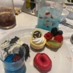 Selection of desserts at PYM Kitchen in Disneyland Paris, including colourful mini cakes and themed treats
