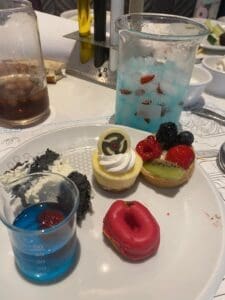 Selection of desserts at PYM Kitchen in Disneyland Paris, including colourful mini cakes and themed treats