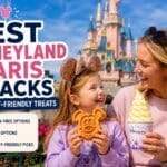 Mother and daughter enjoying a Mickey waffle and soft serve ice cream in front of Disneyland Paris Castle, highlighting the best snacks and allergy-friendly treats at Disneyland Paris.