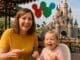 Happy mum and fussy eater toddler dining at Disneyland Paris with castle view
