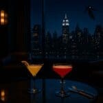 Sophisticated lounge at Skyline Bar, Disney Hotel New York, with cocktails and nighttime cityscape featuring Iron Man