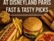 Selection of quick service meals including burger, hot dog, fries, pizza, churros, and cookies at Disneyland Paris