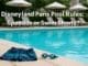A friendly hotel poolside scene at Disneyland Paris, with swim shorts and goggles on the deck, lounge chairs and umbrellas in the background, and overlaid text asking, “Disneyland Paris Pool Rules: Speedos or Swim Shorts?”