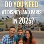 Family at Disneyland Paris looking at a park map with Sleeping Beauty Castle in the background