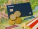 Revolut card and euro coins on a Disneyland Paris park map with popcorn – guide to tipping and payments in France.