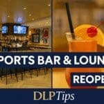The Sports Bar & Lounge at Disney Village, Disneyland Paris, has reopened with a stylish new interior, refreshed menu, and relaxed family-friendly vibe. Image shows the bright bar area and signature cocktail with DLP Tips branding.