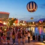 Disney Village entertainment area at Disneyland Paris with evening lights, restaurants and balloon ride