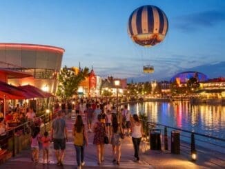 Disney Village entertainment area at Disneyland Paris with evening lights, restaurants and balloon ride