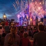 Disneyland Paris nighttime show with castle fireworks and crowds watching parade entertainment in 2026