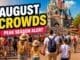 Disneyland Paris August crowds guide showing very busy peak summer crowds walking toward castle in hot sunny weather