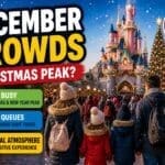 Disneyland Paris December crowds guide with festive Christmas decorations, busy holiday crowds, family walking toward castle and winter season atmosphere