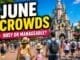 Disneyland Paris June crowds guide with family walking toward castle in sunny weather and moderate crowds